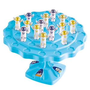 Children playing Balance Astronaut Stacking Game with colorful astronaut pieces and dice on a table