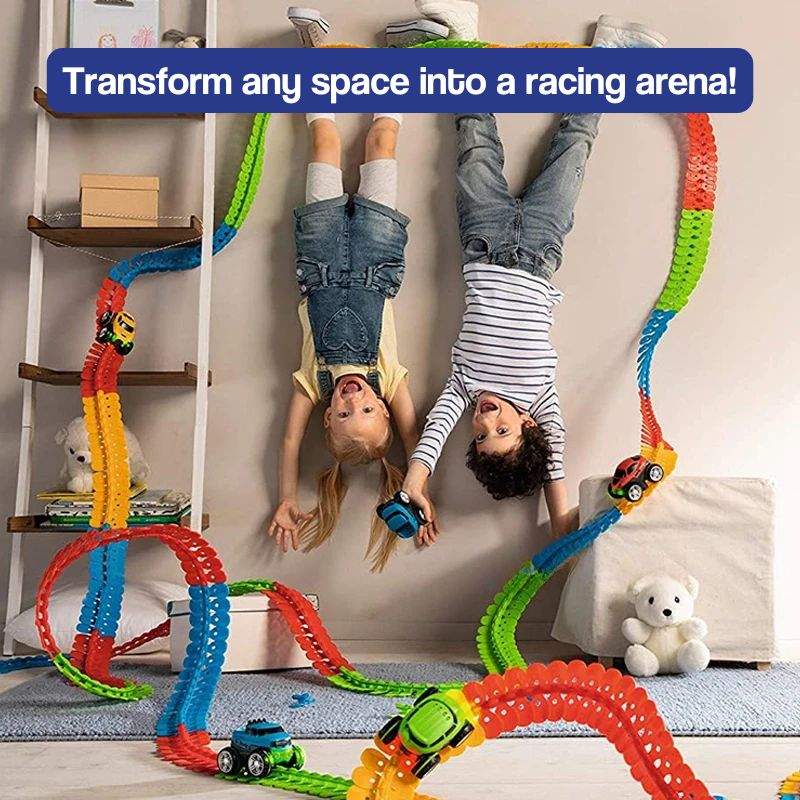 Kids playing with colorful LED anti-gravity race track with loops and stunts indoors