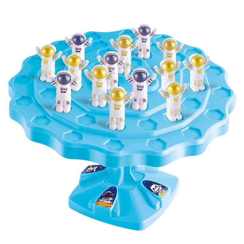 Children playing Balance Astronaut Stacking Game with colorful astronaut pieces and dice on a table